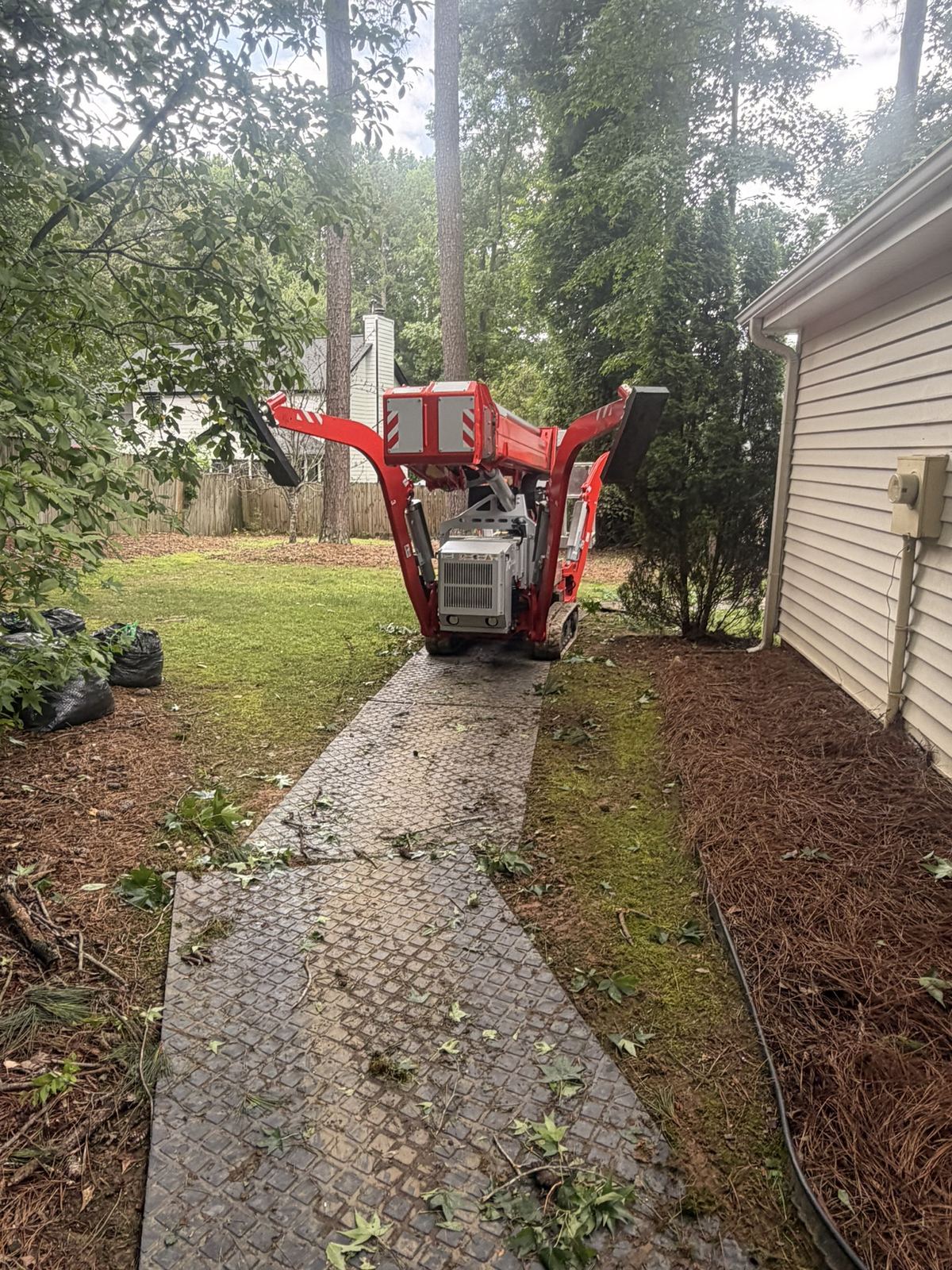 Mats laid along the side of a house to protect the lawn and beds